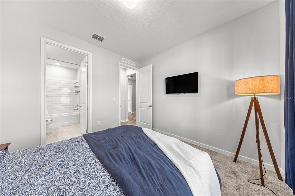 4472 Southwest 84th St Road Ocala, FL 34476 - Photo 9 of 50 a bedroom with a bed and a flat screen tv