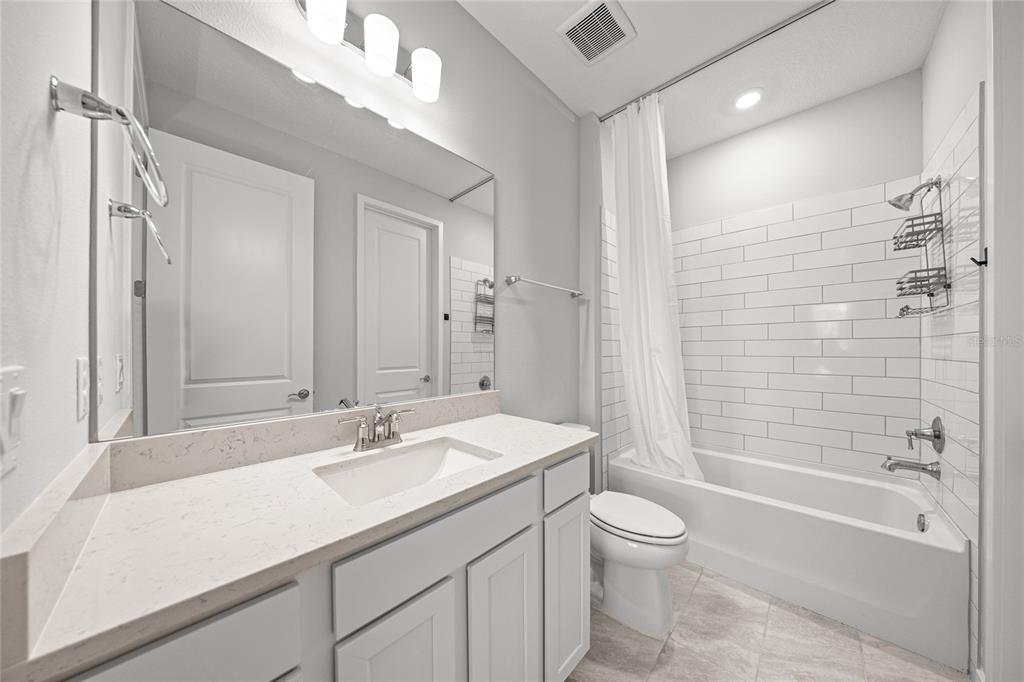 4472 Southwest 84th St Road Ocala, FL 34476 - Photo 10 of 50 a bathroom with a granite countertop sink a toilet and shower