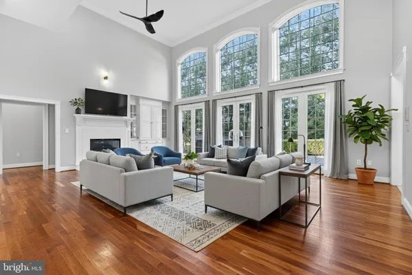 a view of empty room with wooden floor and fireplace