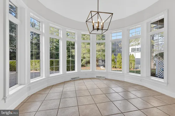a hallway with cabinets and wooden floor