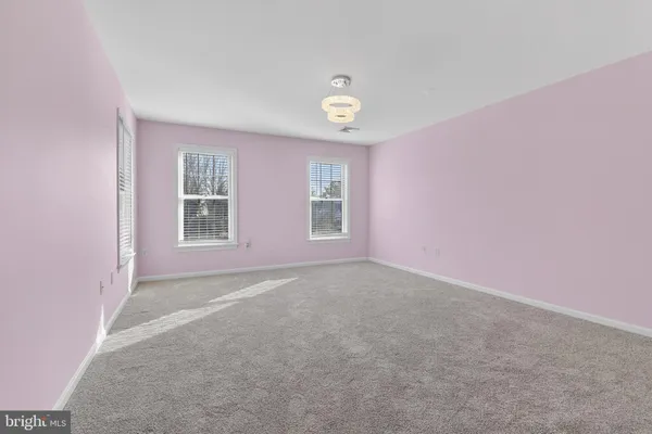 a view of an empty room and a window