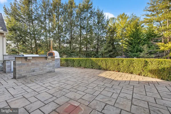 a view of house with backyard and sitting area