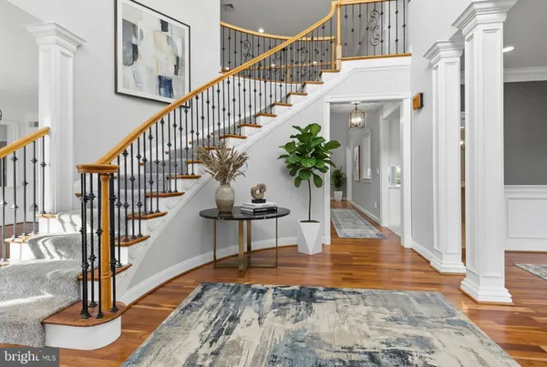 a view of entryway and hall with wooden floor
