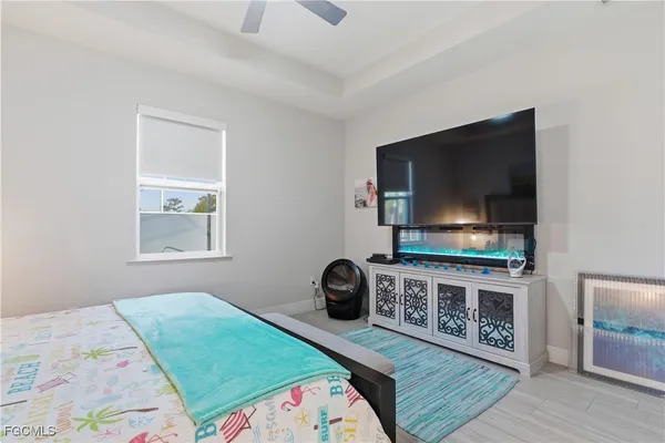 a bedroom with bed and a flat screen tv