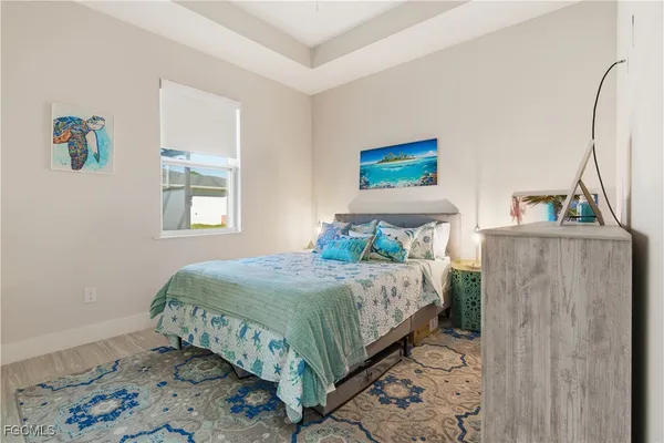 a bedroom with a large bed and a lamp
