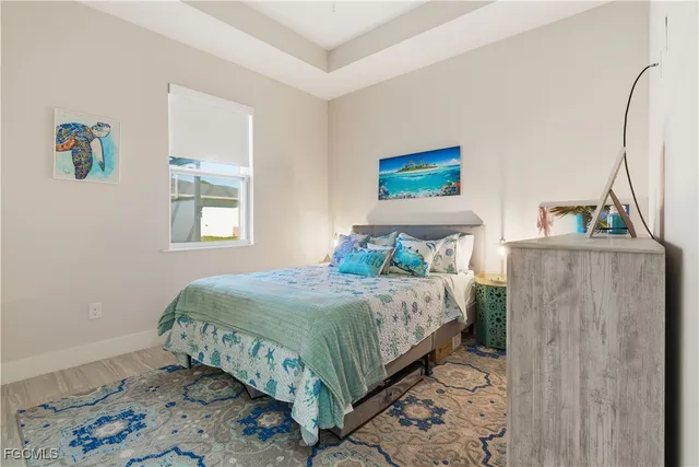 a bedroom with a large bed and a lamp