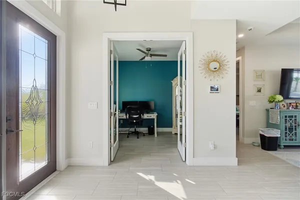 a view of a hallway to a livingroom and a livingroom with furniture