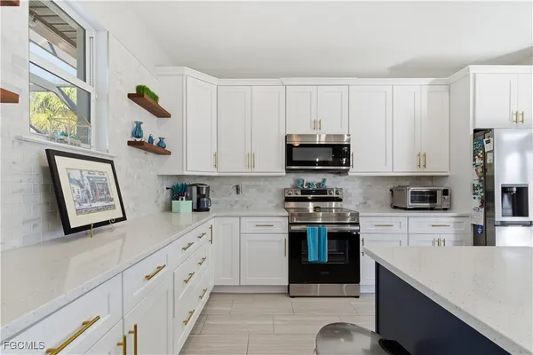 a kitchen with cabinets and stainless steel appliances