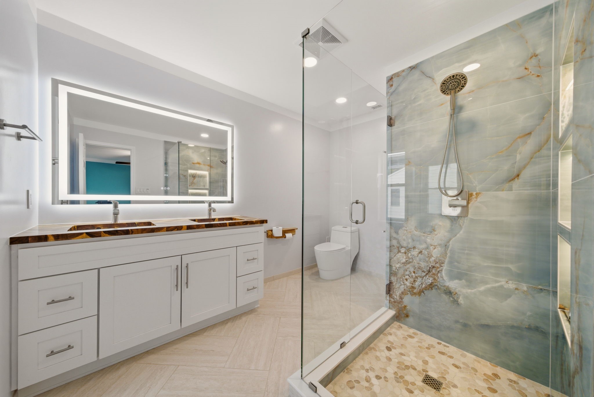 6452 Burgoyne Road, Unit 100 Houston, TX 77057 - Photo 25 of 44 a spacious bathroom with a granite countertop sink mirror and a shower