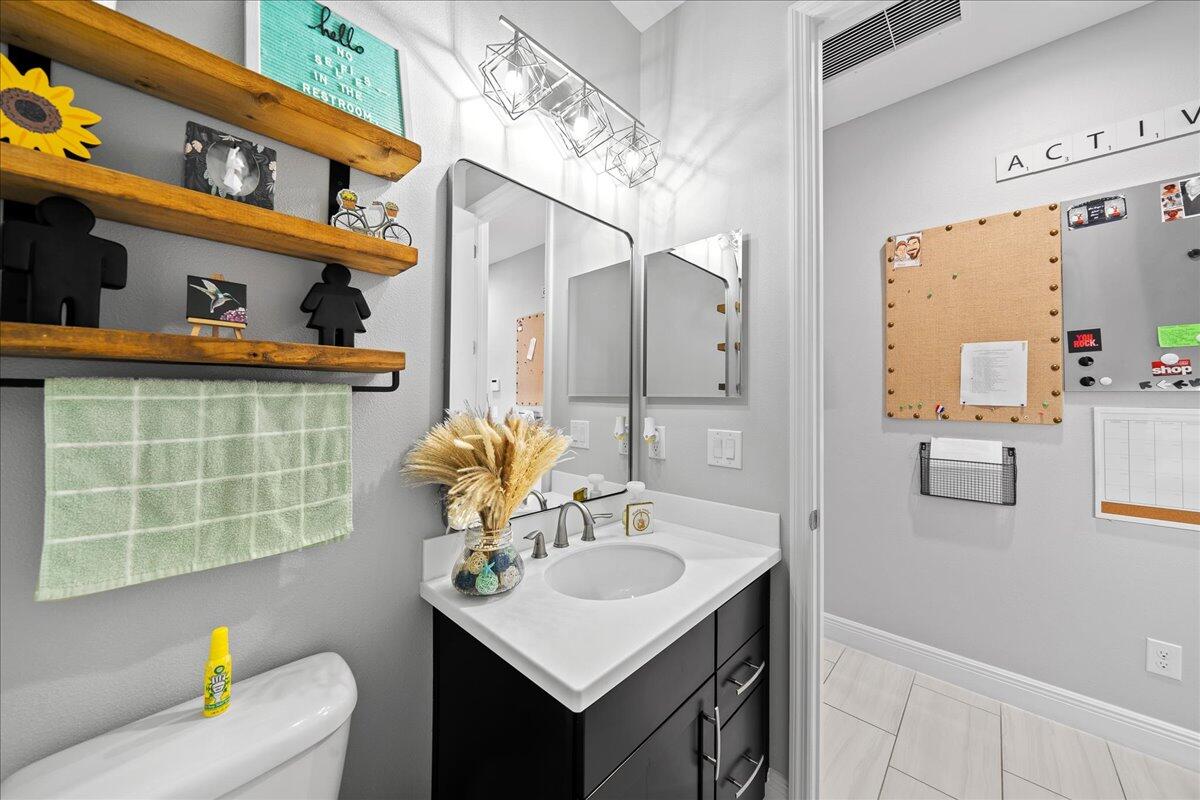 3447 Caviston Way Melbourne, FL 32940 - Photo 14 of 57 a bathroom with a sink toilet and shower