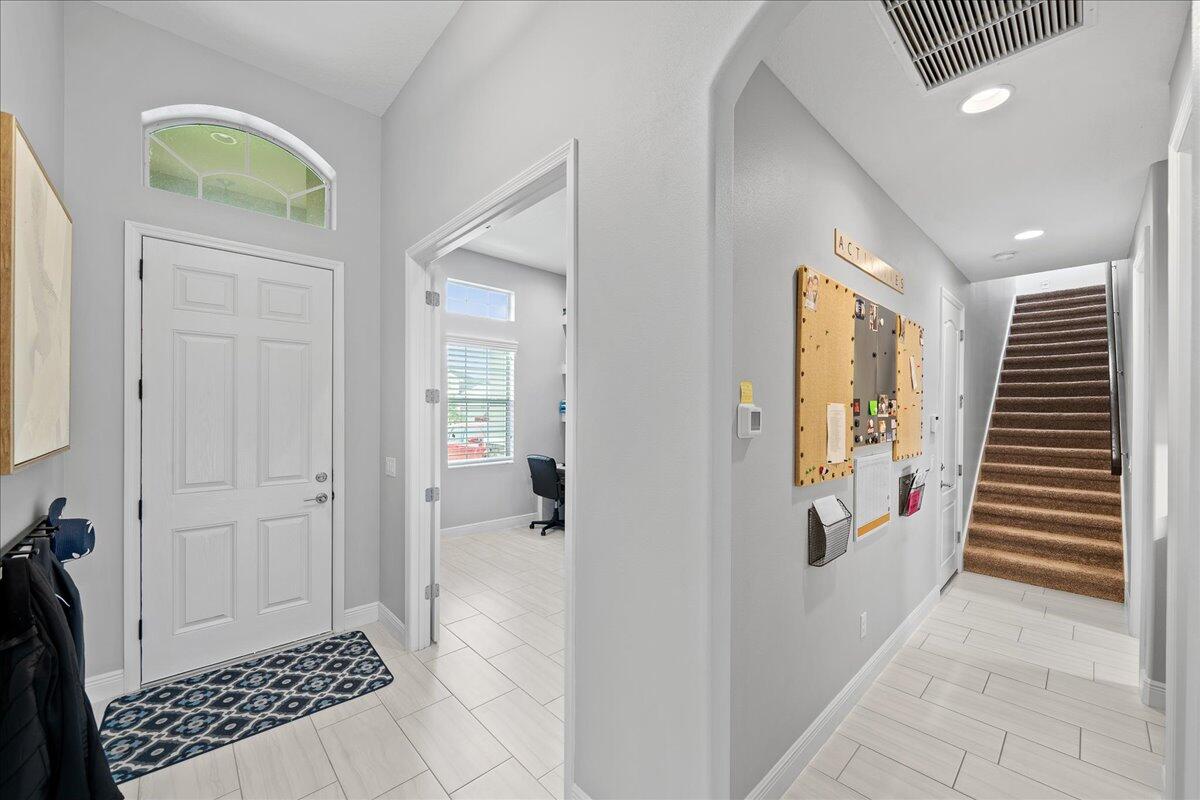 3447 Caviston Way Melbourne, FL 32940 - Photo 24 of 57 a view of a hallway with bathroom and wooden floor