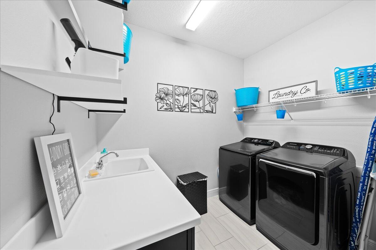 3447 Caviston Way Melbourne, FL 32940 - Photo 29 of 57 a utility room with dryer and washer