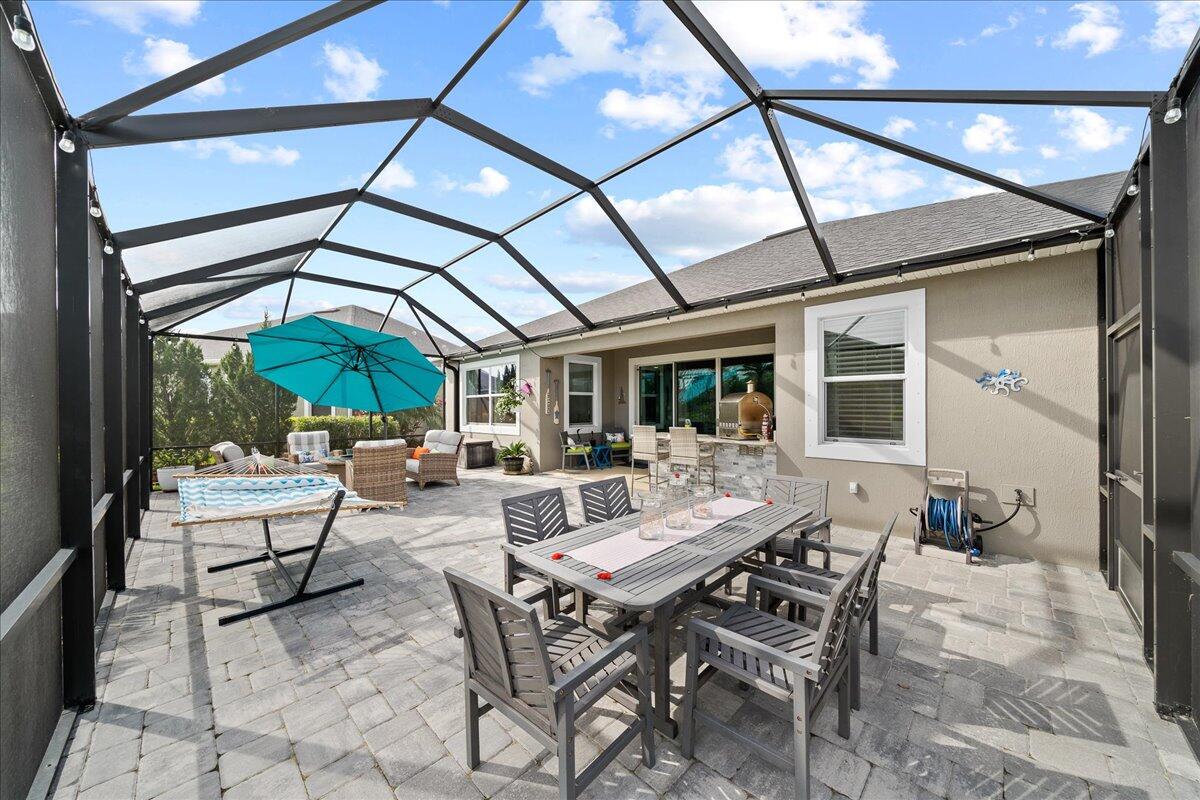 3447 Caviston Way Melbourne, FL 32940 - Photo 4 of 57 a view of patio with table and chairs and potted plants