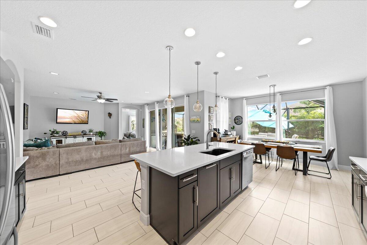 3447 Caviston Way Melbourne, FL 32940 - Photo 8 of 57 a large kitchen with kitchen island a large counter space and stainless steel appliances