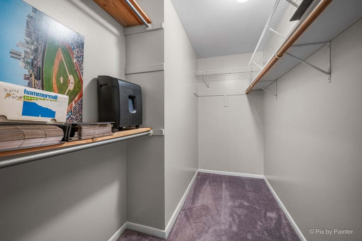 1311 South Finley Road, Unit 104 Lombard, IL 60148 - Photo 11 of 15 a view of a hallway with paintings on the wall