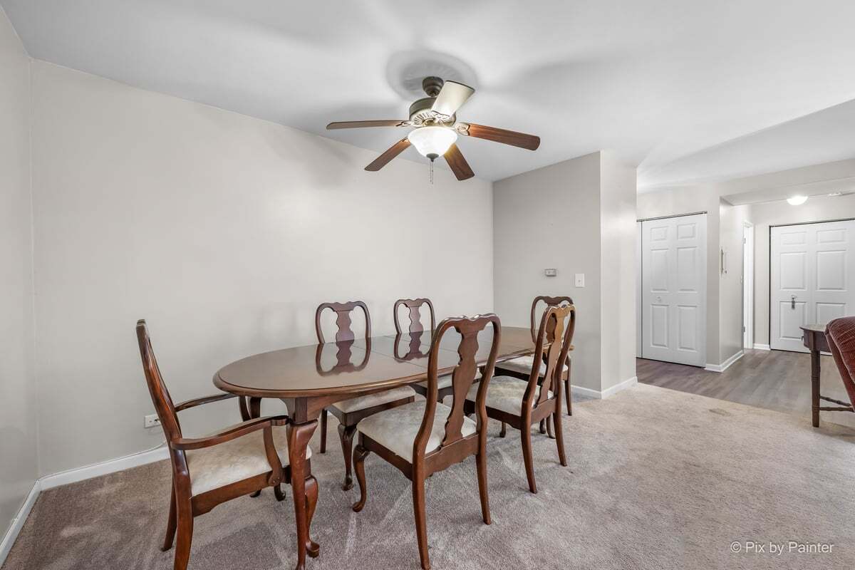 1311 South Finley Road, Unit 104 Lombard, IL 60148 - Photo 4 of 15 a dining room with furniture and a chandelier