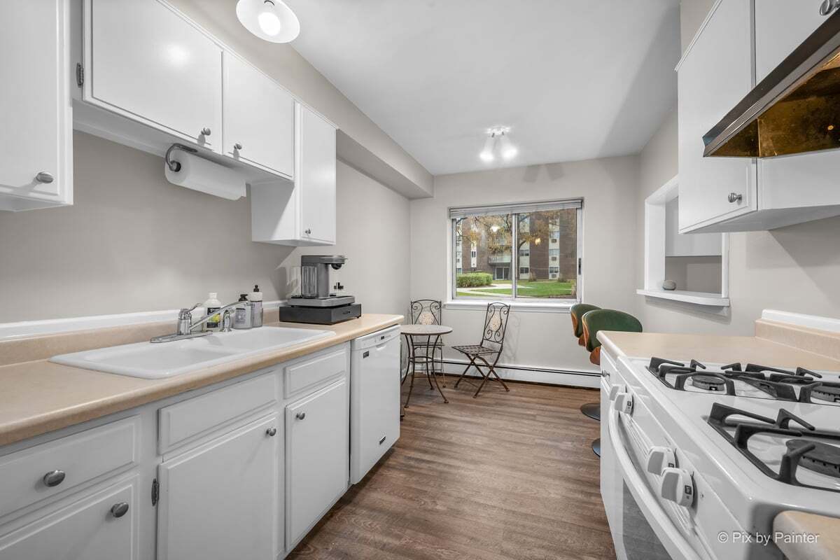1311 South Finley Road, Unit 104 Lombard, IL 60148 - Photo 5 of 15 a kitchen with stove a sink and cabinets