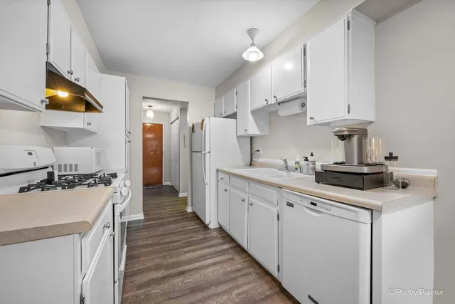 a kitchen with cabinets and a stove