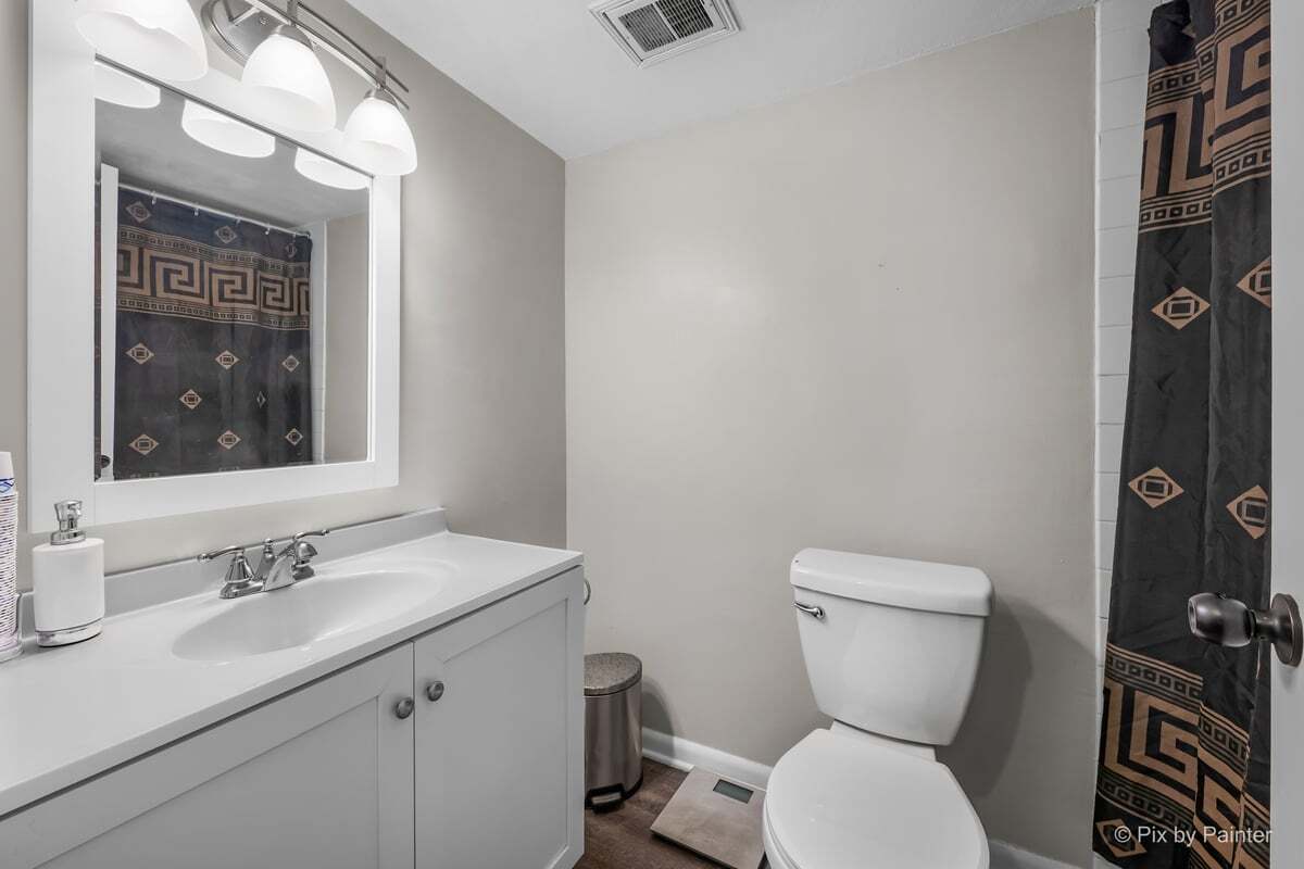 1311 South Finley Road, Unit 104 Lombard, IL 60148 - Photo 8 of 15 a bathroom with a toilet sink and mirror