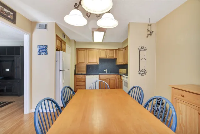 a kitchen with stainless steel appliances granite countertop a refrigerator sink and cabinets