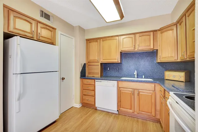 a dining room with furniture a chandelier and wooden floor