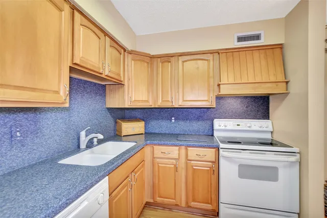 a dining room with furniture potted plants and wooden floor