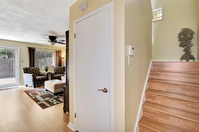 a living room with a bed and a flat screen tv
