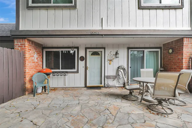 a view of a chair and tables in the patio with a chair