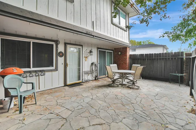 a view of a house with backyard and sitting area