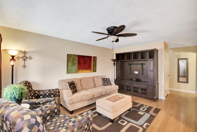 a living room with furniture and wooden floor