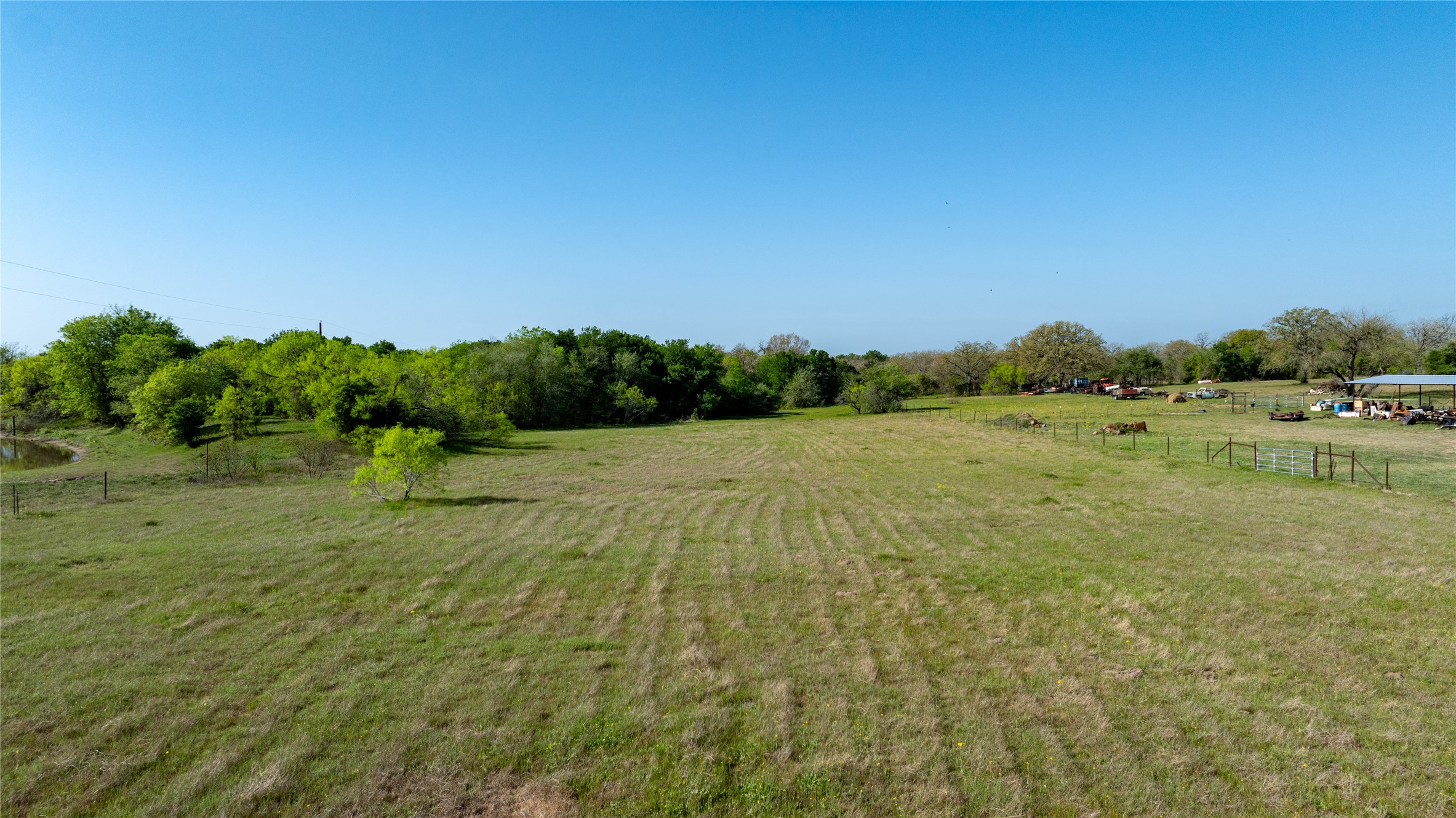 6575 Taylorsville Road Dale, TX 78616 - Photo 10 of 15 A sprawling green expanse awaits, ideal for development or agricultural pursuits.