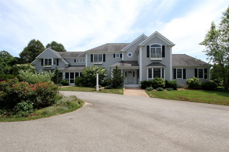 29 Farm Valley Road Osterville, MA 02655 - Photo 1 of 24 a front view of a house with a yard and garage
