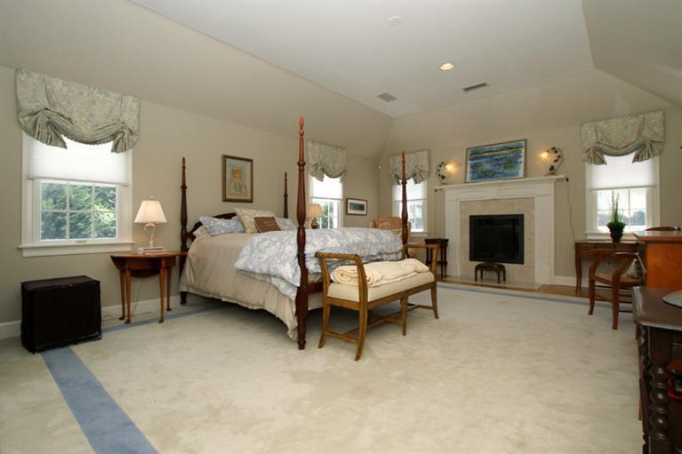 29 Farm Valley Road Osterville, MA 02655 - Photo 15 of 24 a bedroom with a bed chair and fireplace
