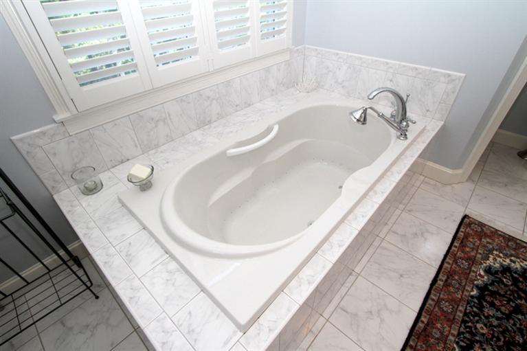 29 Farm Valley Road Osterville, MA 02655 - Photo 16 of 24 a bath tub sitting in a bathroom next to a window