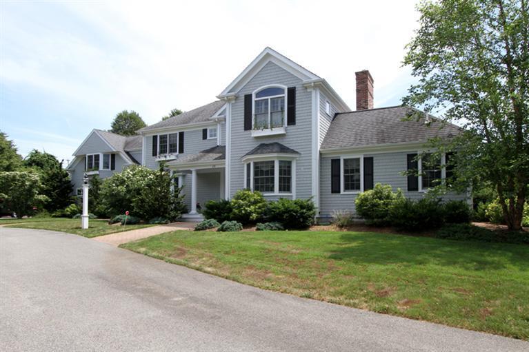 29 Farm Valley Road Osterville, MA 02655 - Photo 2 of 24 a front view of a house with a yard and garage