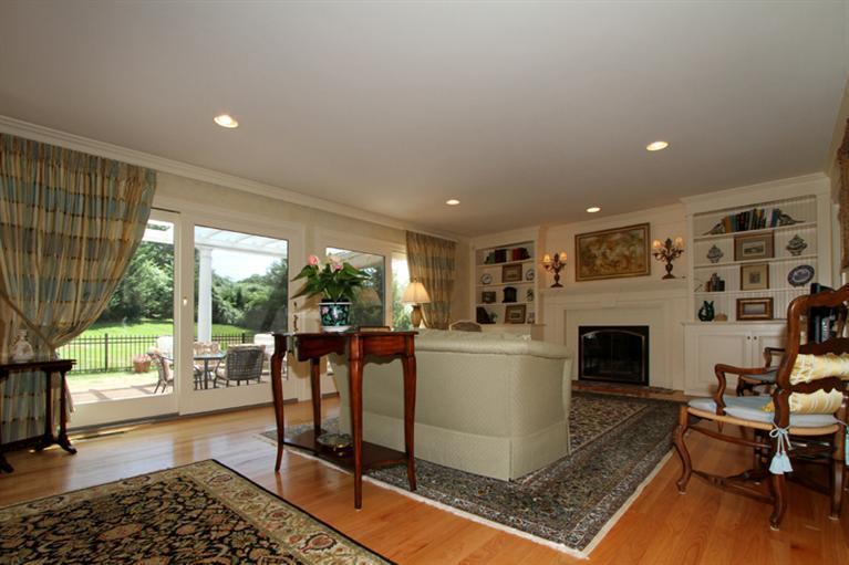 29 Farm Valley Road Osterville, MA 02655 - Photo 9 of 24 a living room with furniture a fireplace and a table