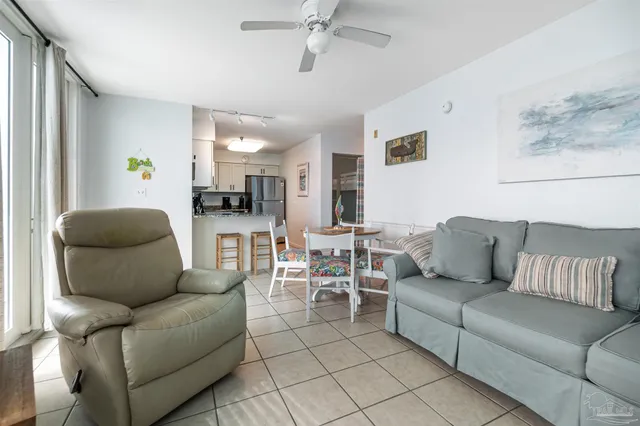 a living room with furniture and a view of kitchen
