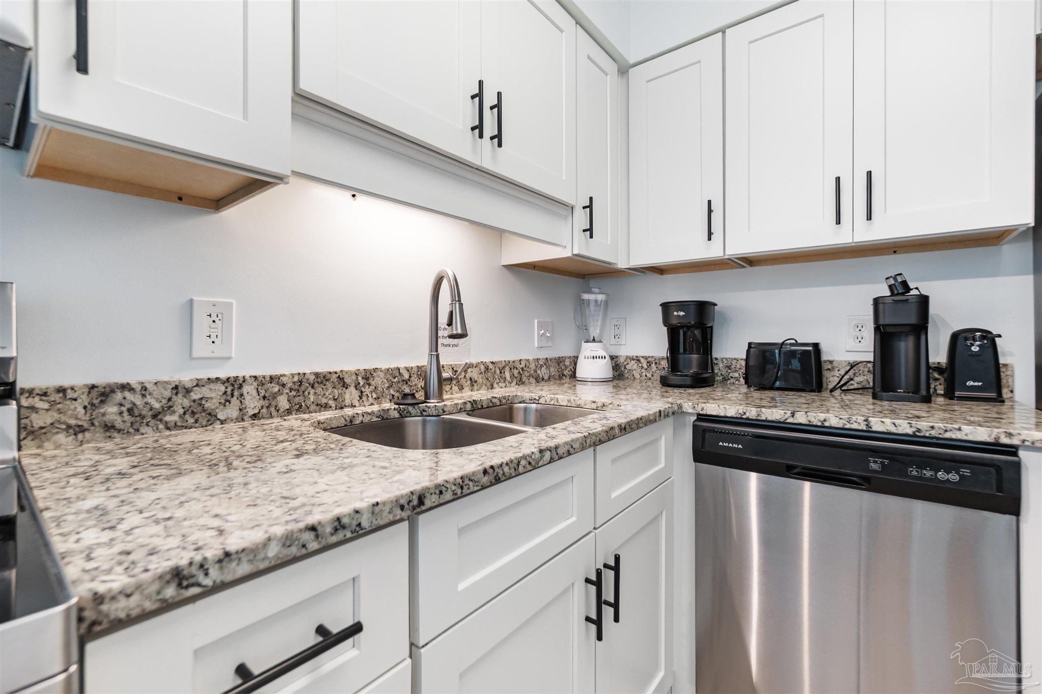 13785 Perdido Key Drive, Unit G3 Perdido Key, FL 32507 - Photo 21 of 30 a kitchen with granite countertop a sink and cabinets