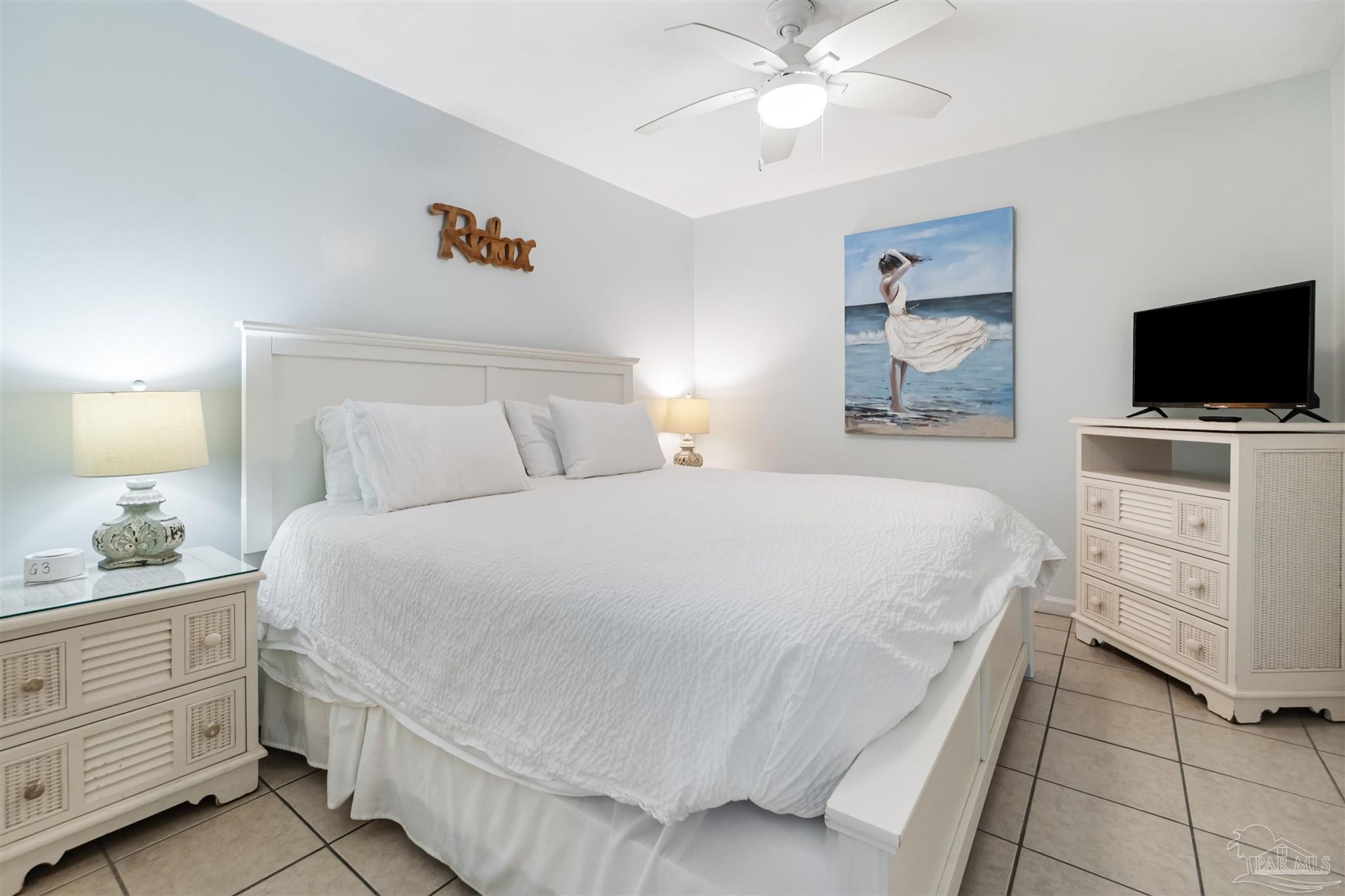 13785 Perdido Key Drive, Unit G3 Perdido Key, FL 32507 - Photo 25 of 30 a bedroom with a bed and a flat screen tv