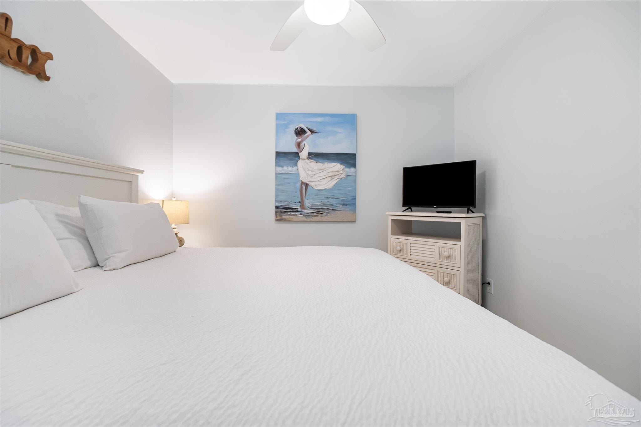 13785 Perdido Key Drive, Unit G3 Perdido Key, FL 32507 - Photo 26 of 30 a bedroom with a bed and a flat screen tv