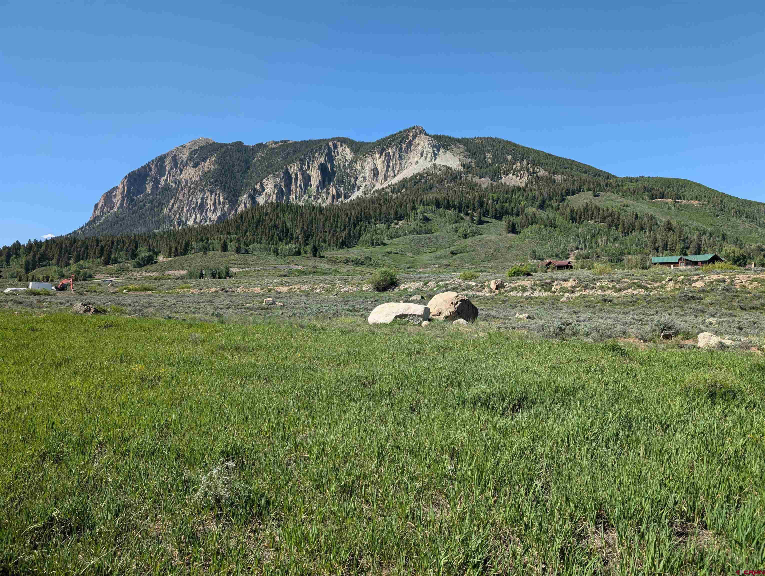 333 South Avion Drive Crested Butte, CO 81224 - Photo 1 of 21 a view of a lush green field with mountains in the background