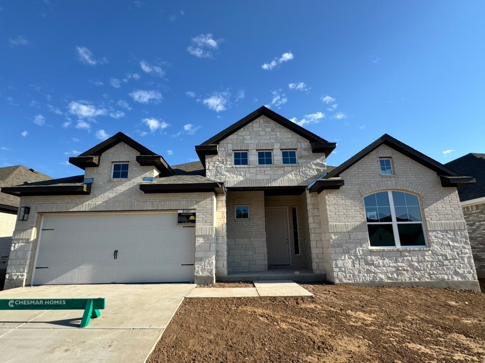 324 Ridgewell Loop Georgetown, TX 78633 - Photo 1 of 1 View of front of home featuring stone siding, driveway, and a garage