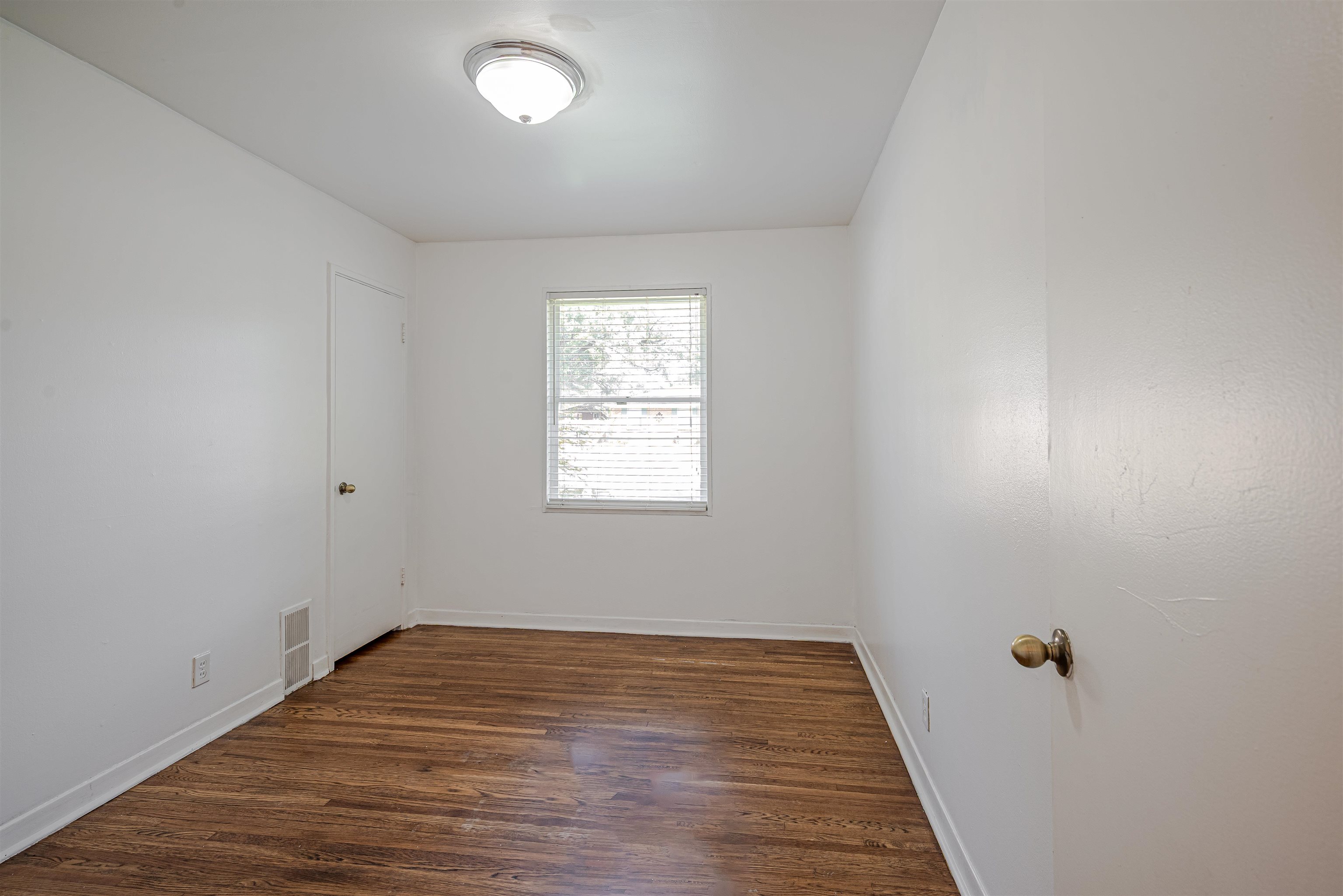 4861 Verne Road Memphis, TN 38117 - Photo 9 of 17 wooden floor in an empty room with a window