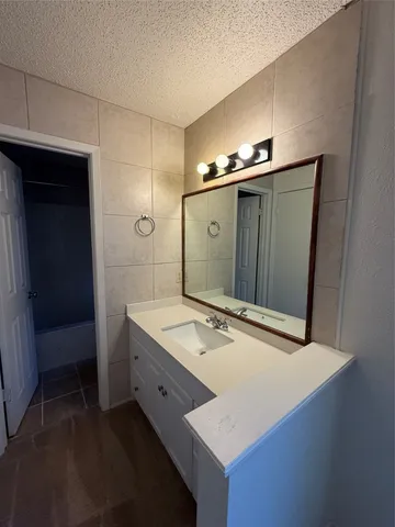 a bathroom with a sink and mirror