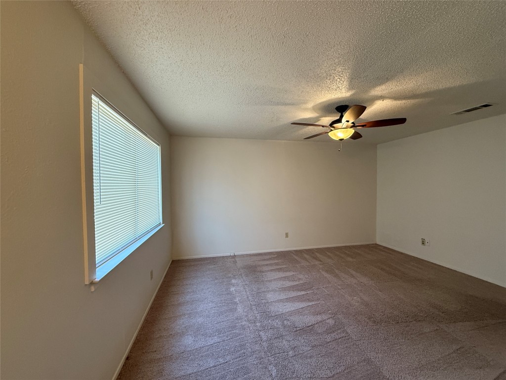 8906 Pineridge Drive Austin, TX 78729 - Photo 15 of 35 an empty room with a fan & a window