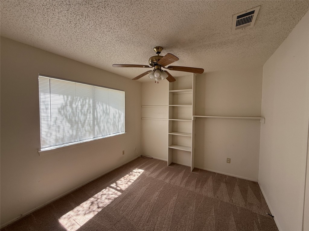 8906 Pineridge Drive Austin, TX 78729 - Photo 16 of 35 a view of an empty room with a window