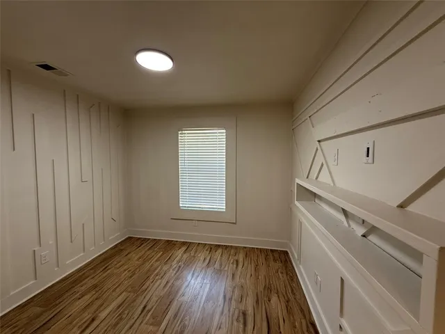 a view of room with window and hardwood floor