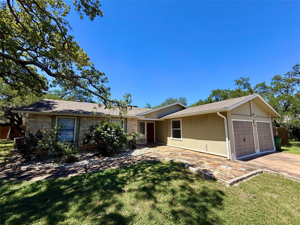 8906 Pineridge Drive Austin, TX 78729 - Photo 2 of 35 a view of a house with a yard