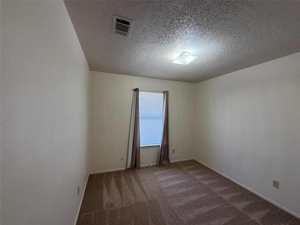 8906 Pineridge Drive Austin, TX 78729 - Photo 22 of 35 an empty room with a bench