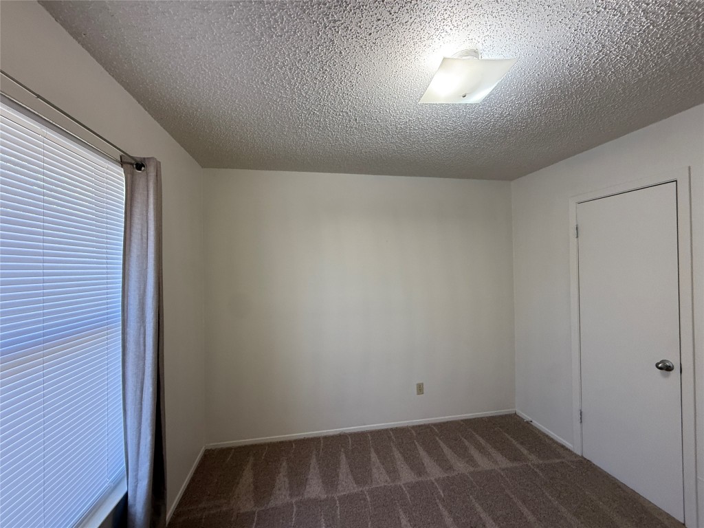 8906 Pineridge Drive Austin, TX 78729 - Photo 23 of 35 an empty room with wooden floor and windows